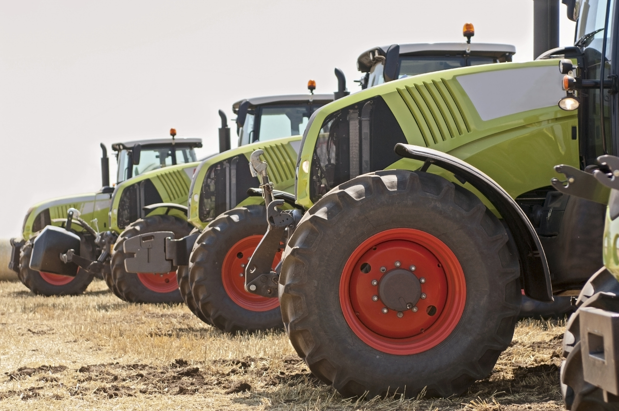 New tractors in a line on field image