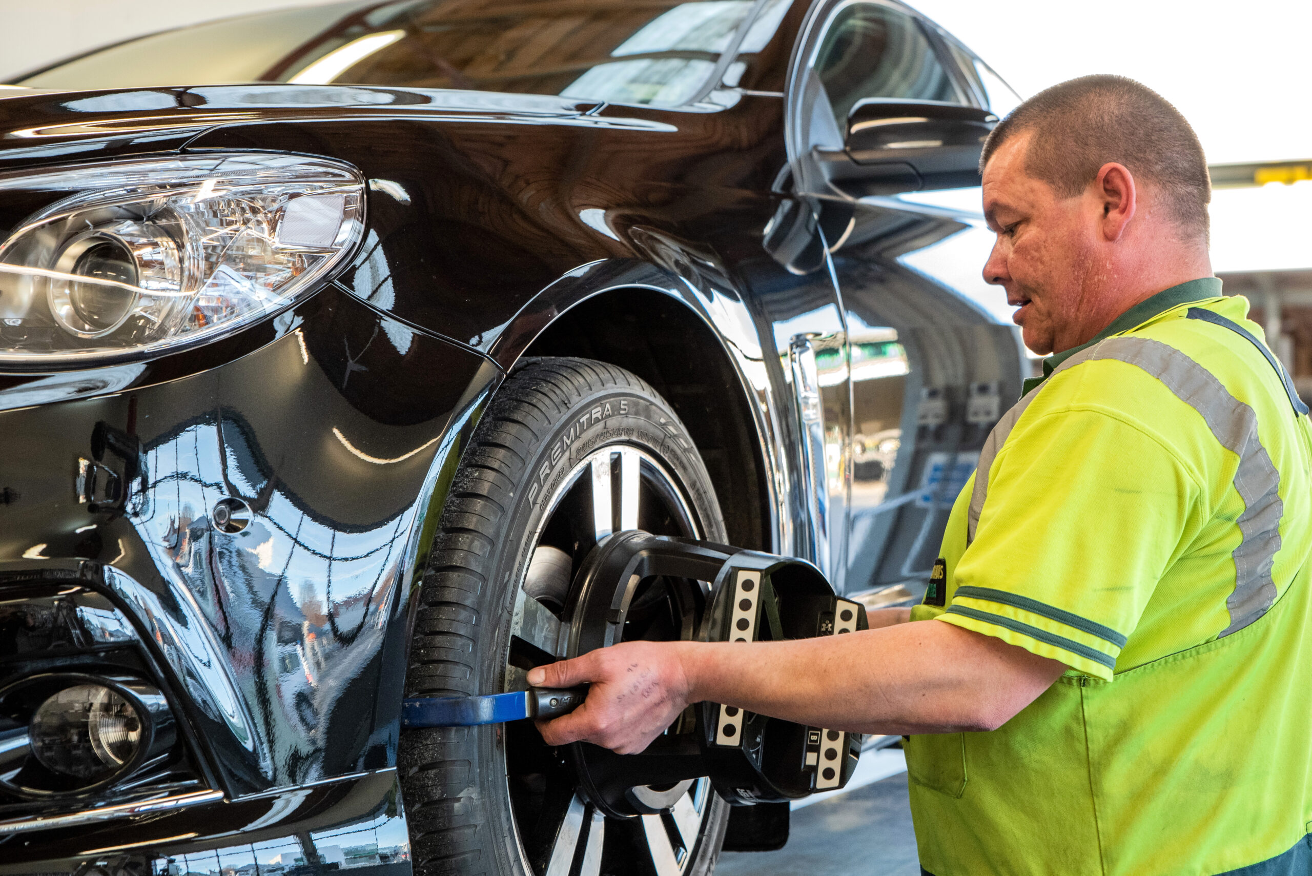 Neumnns Tyres wheel alignment technician performing an alignment.