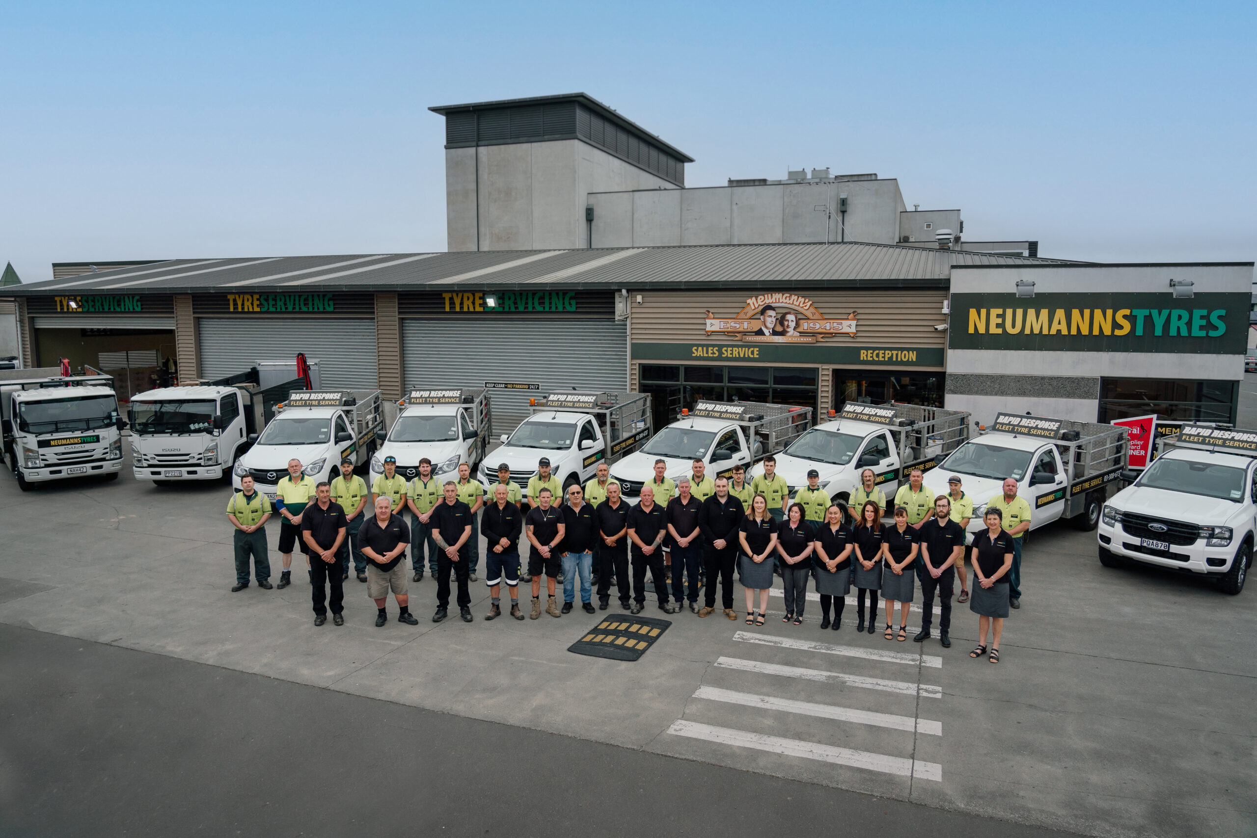 Neumanns Tyres staff outside branch with fleet tyre vechiles.